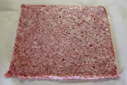 Cut plastic bag away from sausage