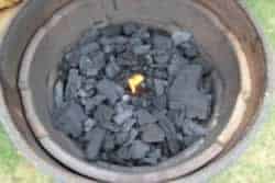 Place a firestarter in the center of the charcoal